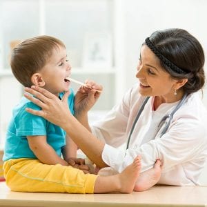 doctor examining little boy