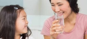 mom and daughter drinking water together