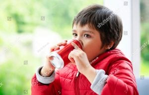 young child drinking soda