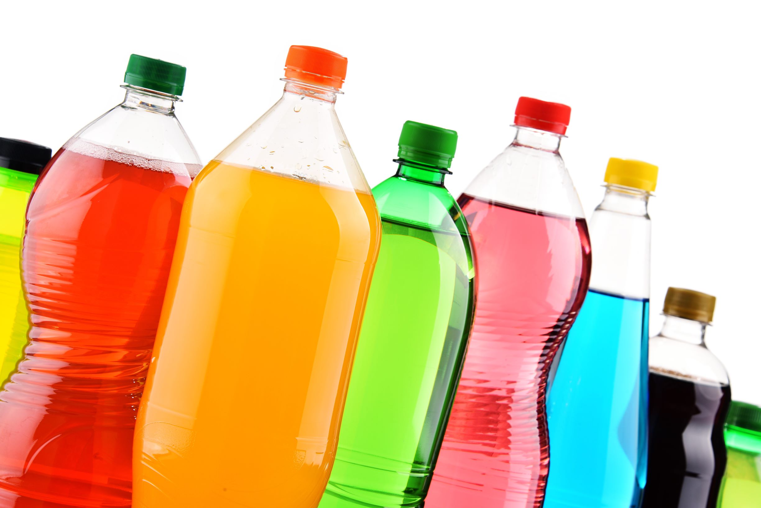 different colored water bottles with soda and juice