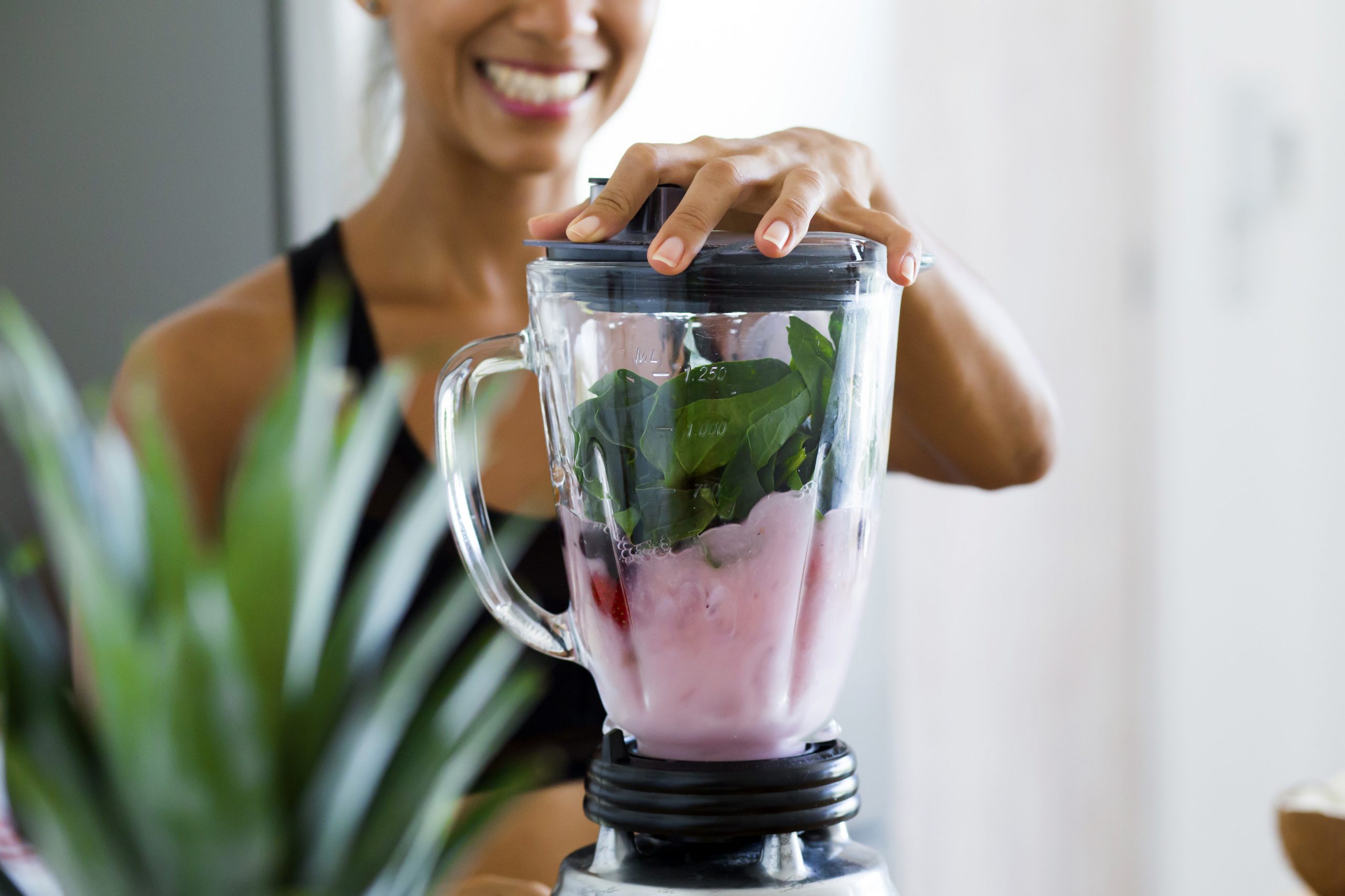 Woman making a colorful smoothie