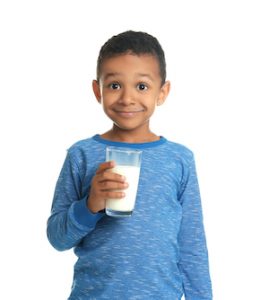 Boy in blue shirt with milk