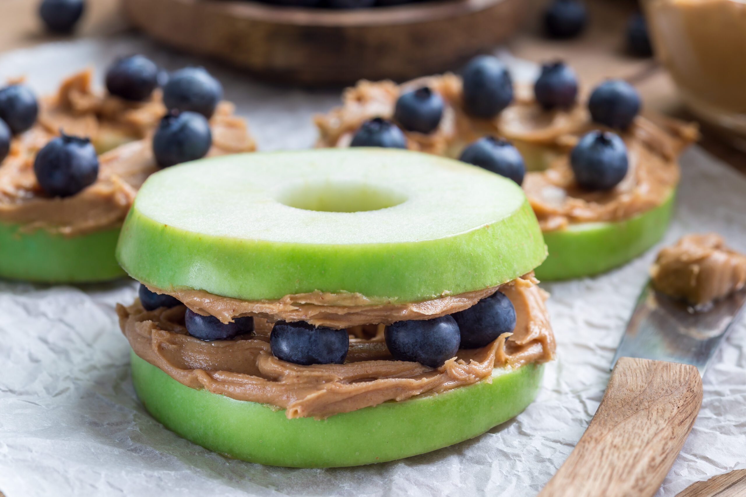 Green apple rounds with peanut butter and blueberries